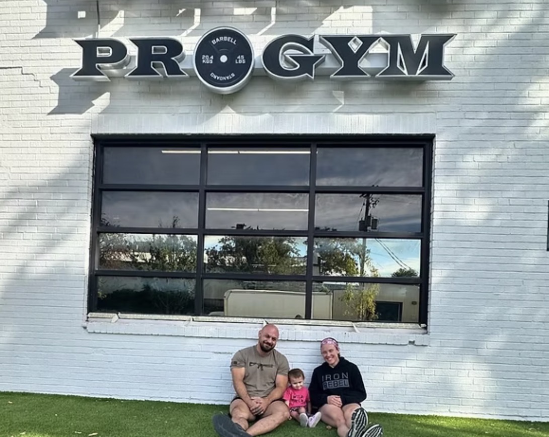 Hailey and Ryan Delf with their daughter outside Delf's Pro Gym